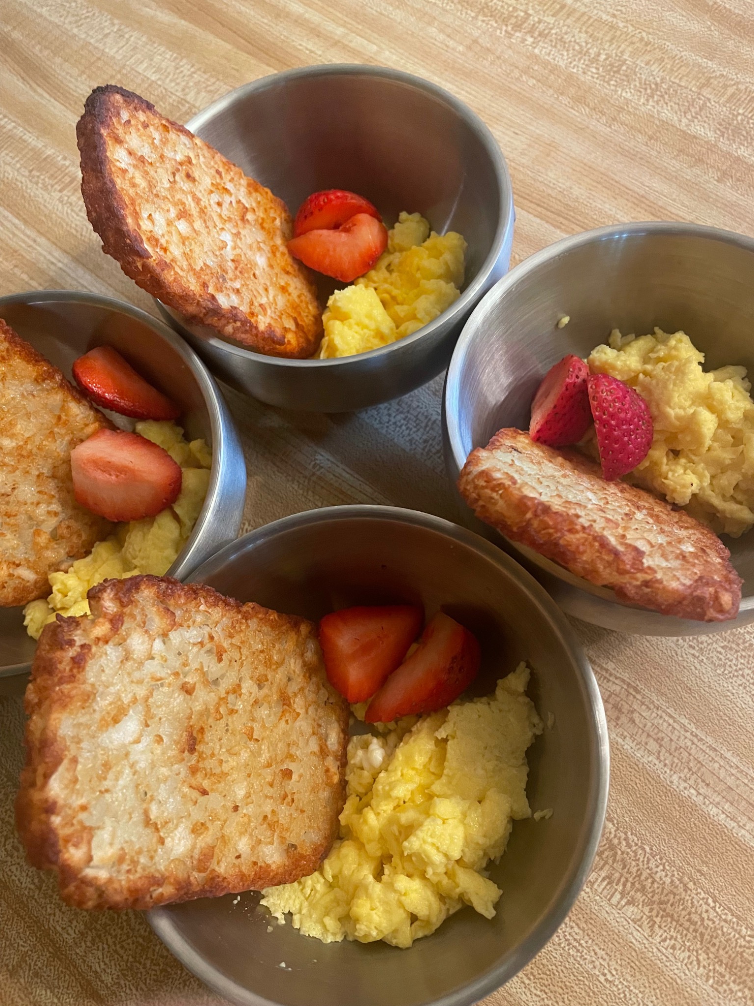 Scrambled eggs & hash browns served in daycare meal trays