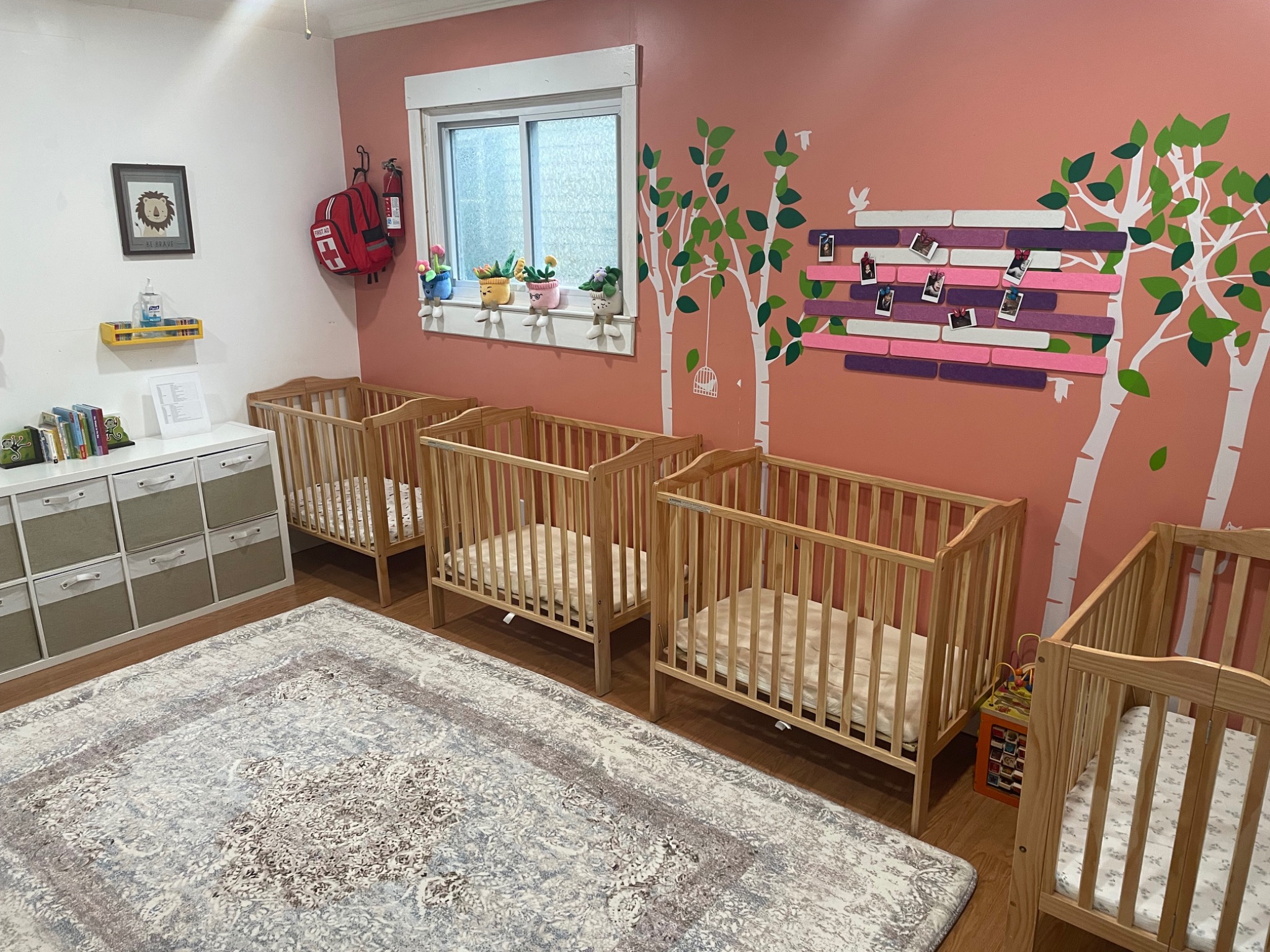 Infant room with cribs and a soft rug