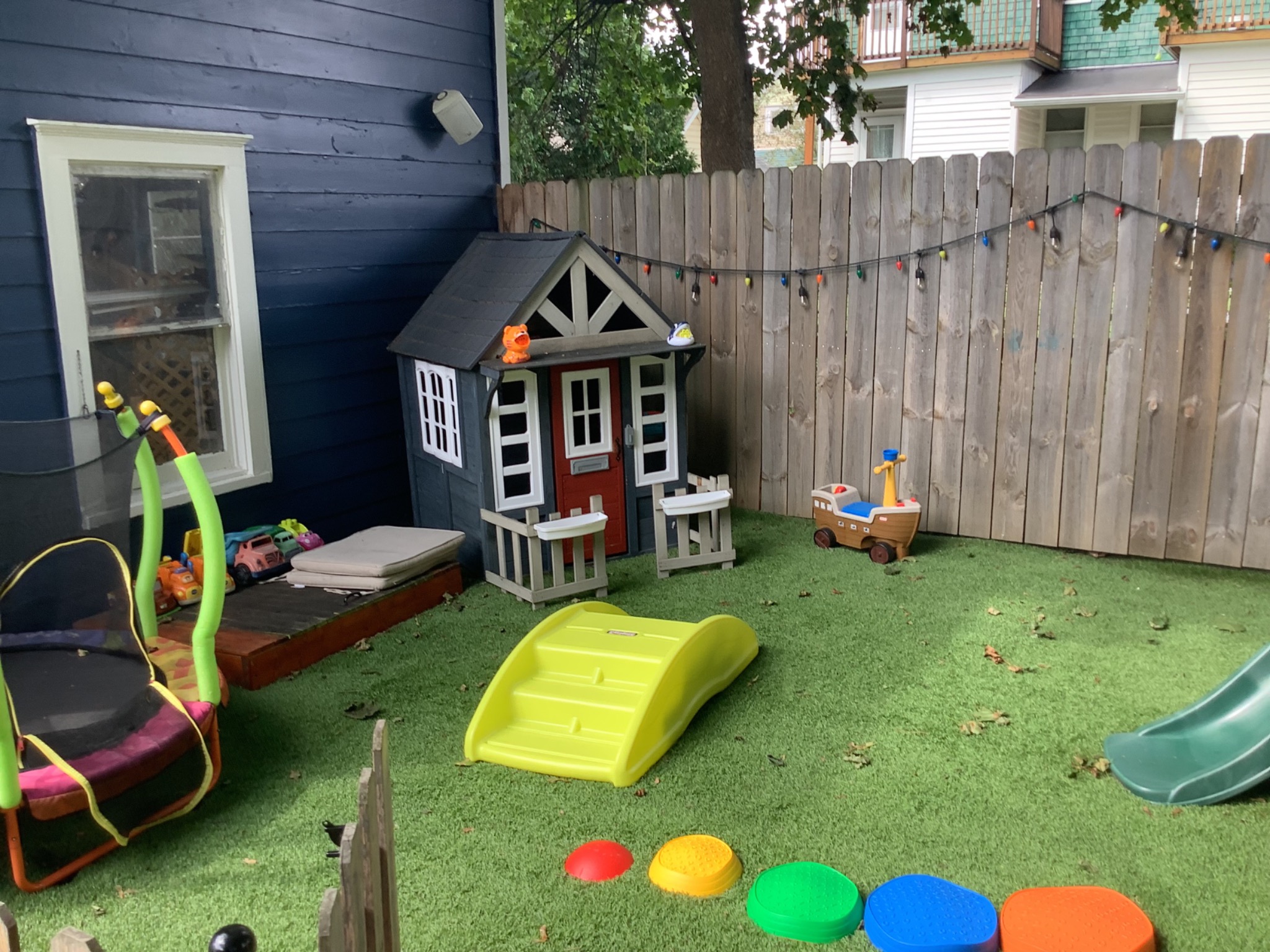 Playhouse and colorful stepping stones in the playground