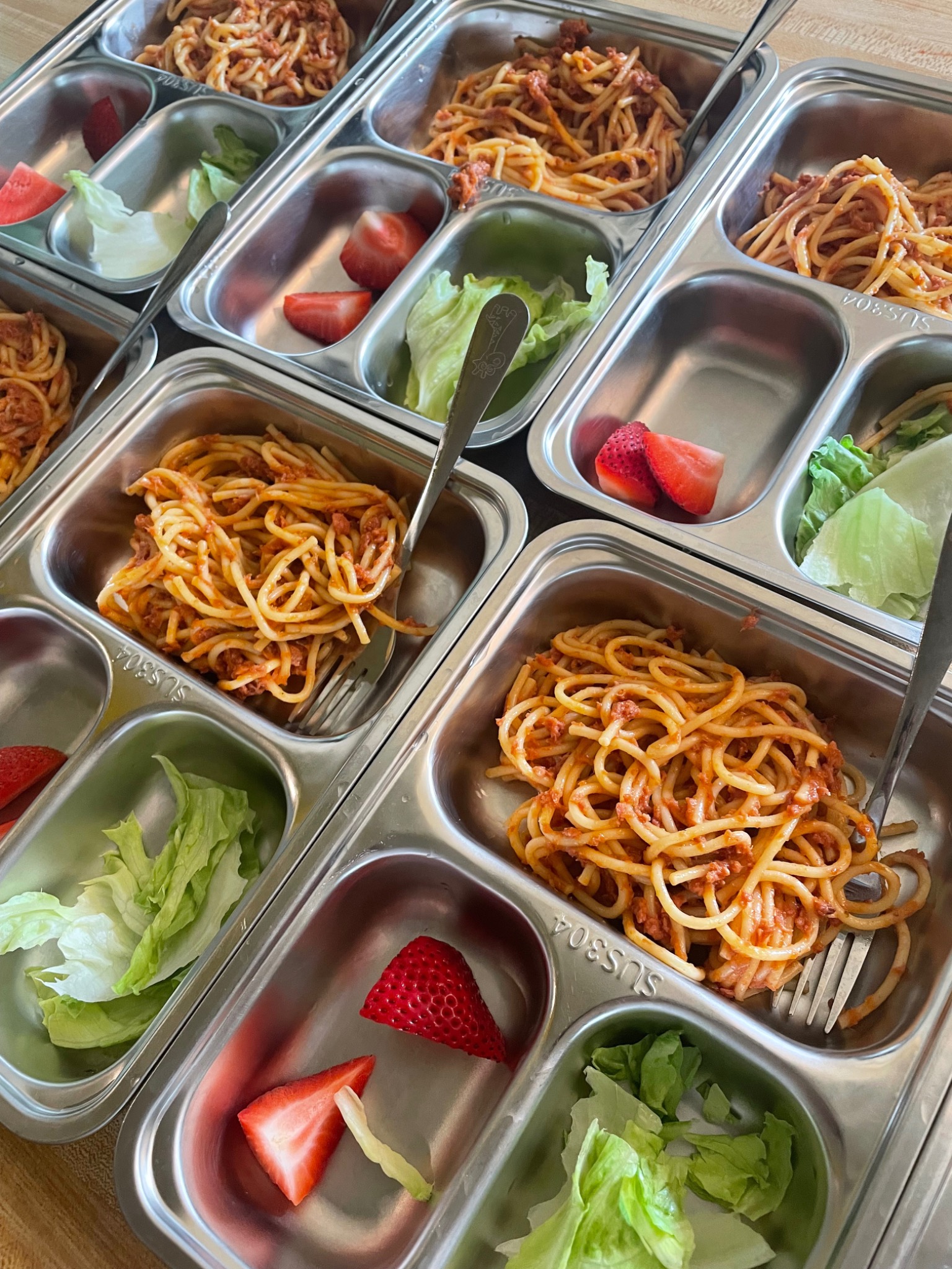 Spaghetti & corned beef served in daycare meal trays
